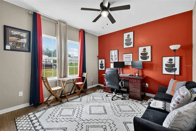 a living room with furniture a rug and a large window