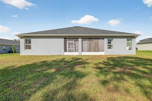 a front view of house with yard and garage