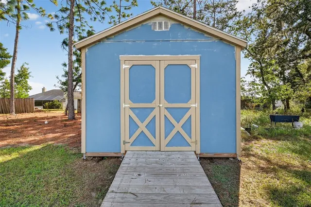 a view of a patio with table and chairs