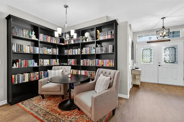 a living room with furniture and a book shelf
