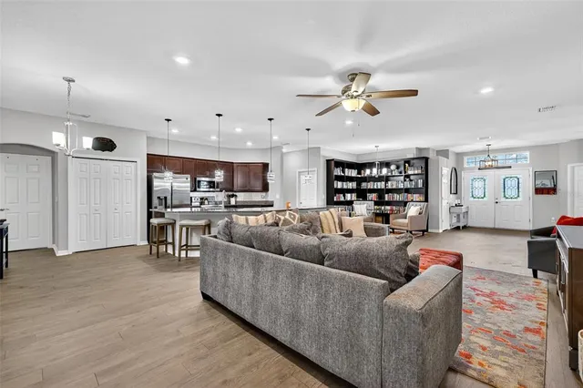 a living room with furniture and kitchen view