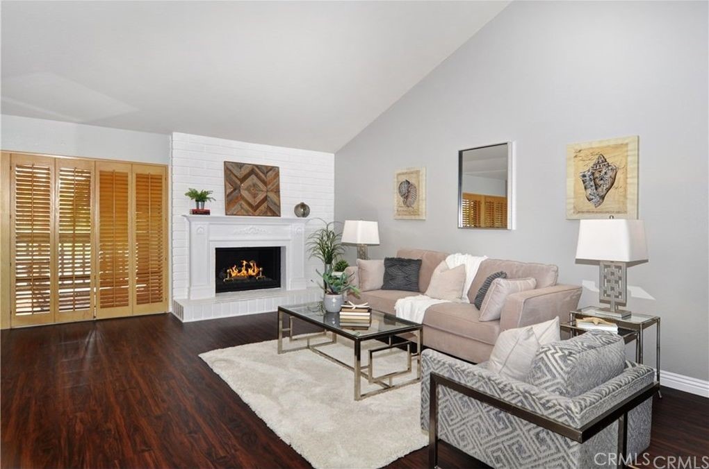 6 Vista, Unit 69 Irvine, CA 92612 - Photo 1 of 1 a living room with furniture and a fireplace