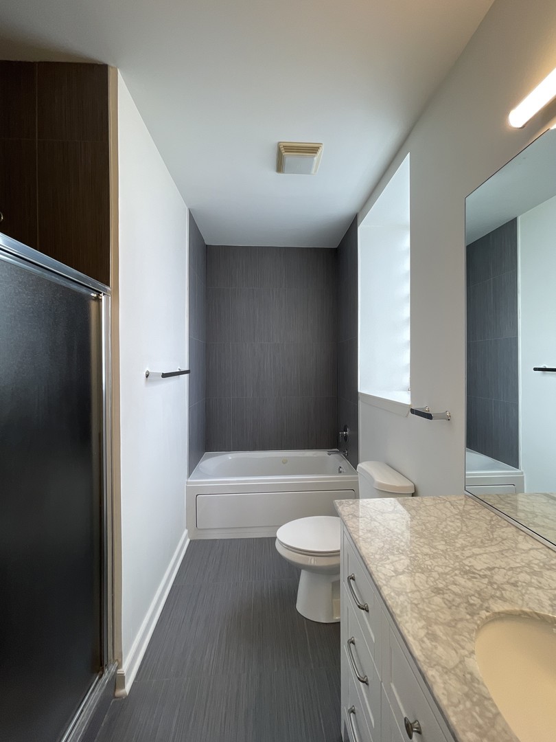 849 West Monroe Street, Unit 3F Chicago, IL 60607 - Photo 13 of 18 a bathroom with a granite countertop sink toilet and shower