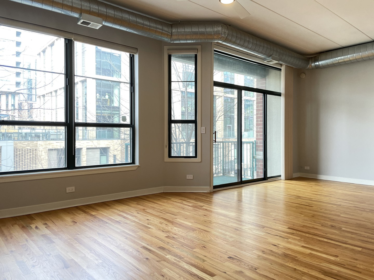 849 West Monroe Street, Unit 3F Chicago, IL 60607 - Photo 2 of 18 a view of an empty room with wooden floor and a window