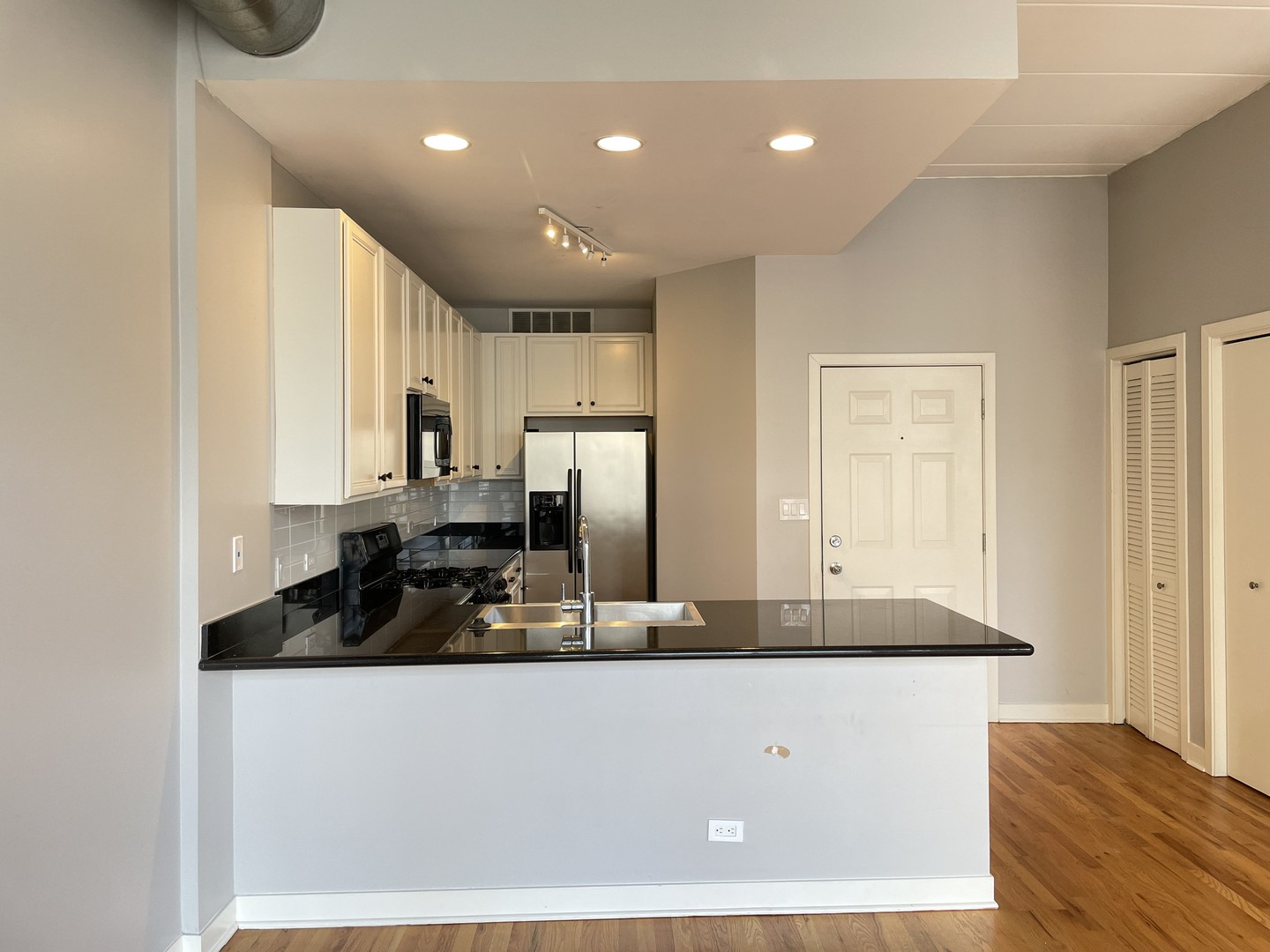 849 West Monroe Street, Unit 3F Chicago, IL 60607 - Photo 4 of 18 a kitchen with kitchen island granite countertop a sink and refrigerator