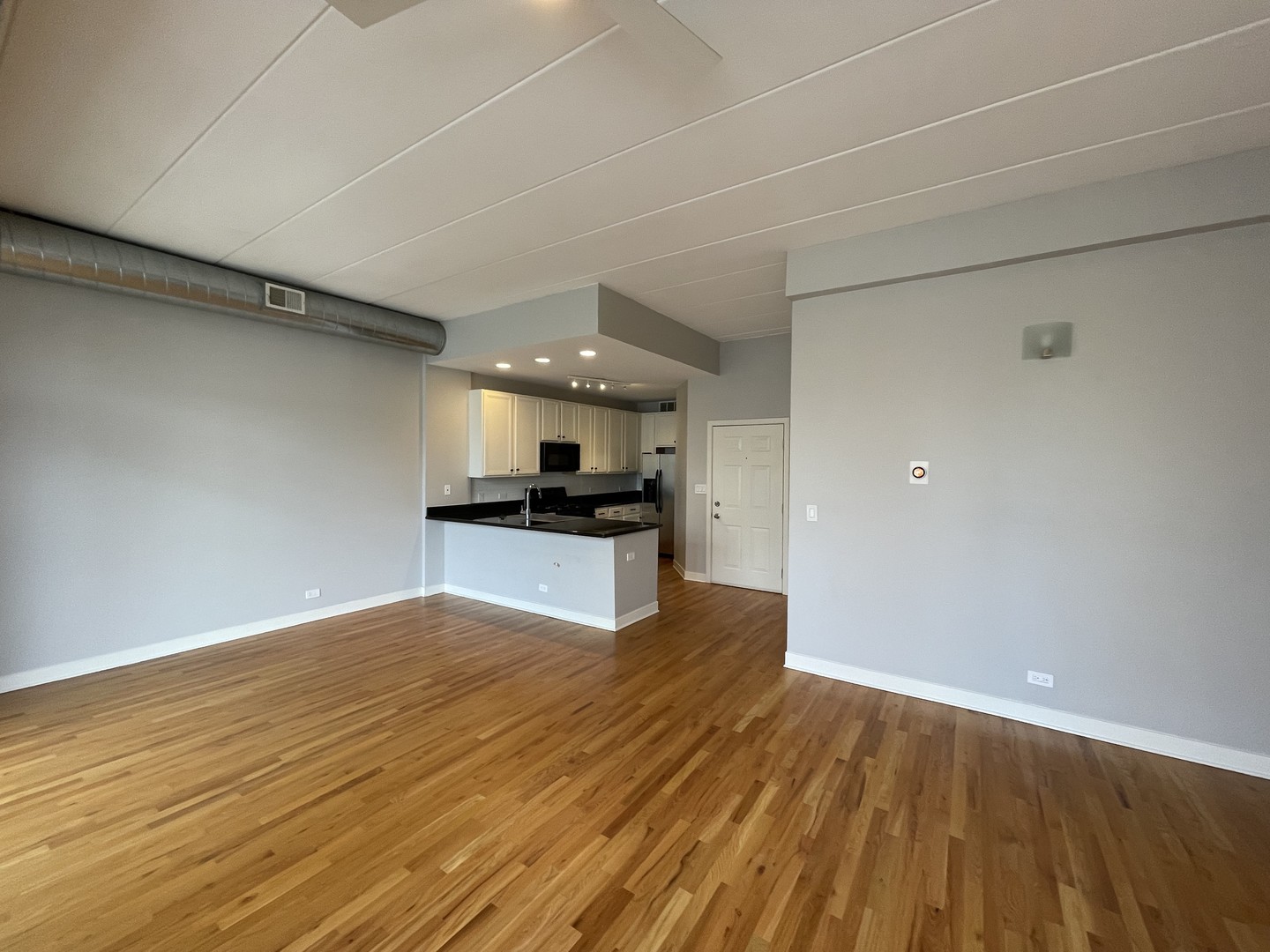 849 West Monroe Street, Unit 3F Chicago, IL 60607 - Photo 6 of 18 a view of kitchen and empty room with wooden floor