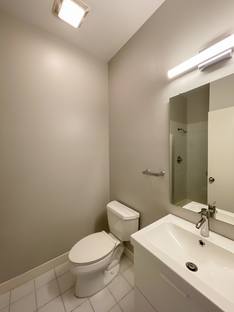 849 West Monroe Street, Unit 3F Chicago, IL 60607 - Photo 7 of 18 a bathroom with a sink a toilet and mirror