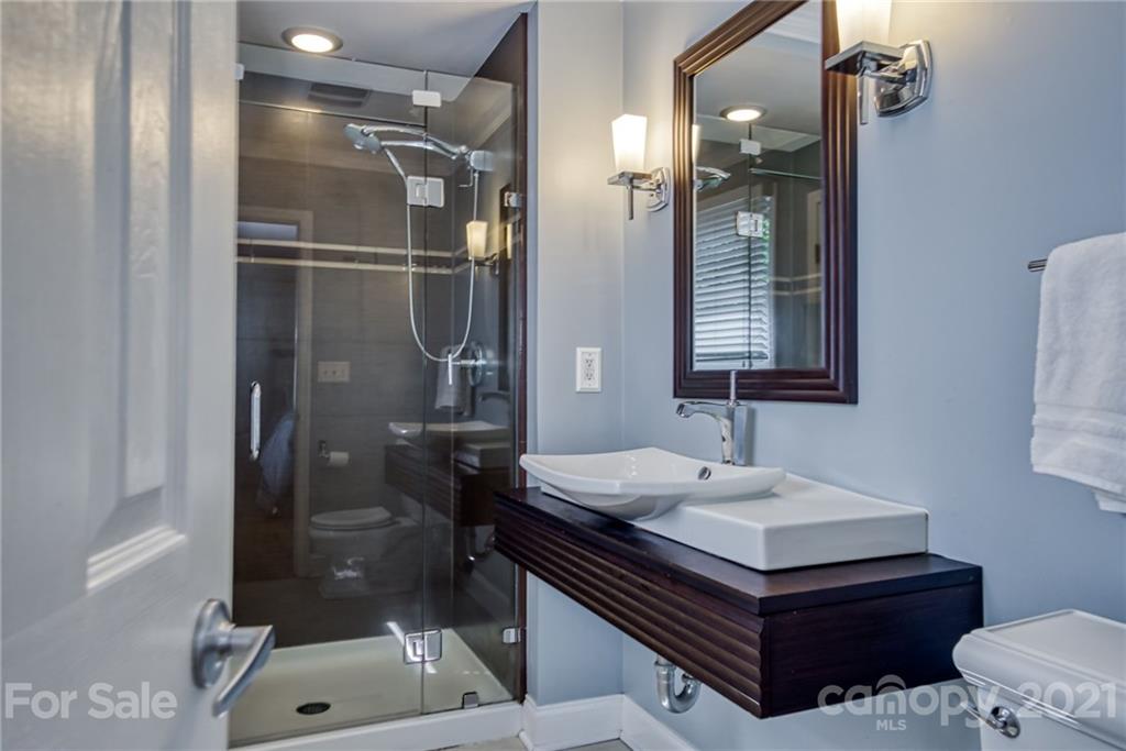 5401 Valley Forge Road Charlotte, NC 28210 - Photo 21 of 27 a bathroom with a sink mirror and a shower