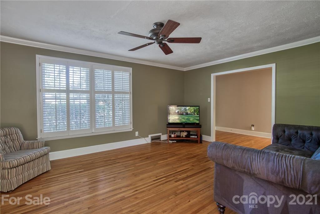 5401 Valley Forge Road Charlotte, NC 28210 - Photo 5 of 27 a living room with furniture and a flat screen tv with wooden floor