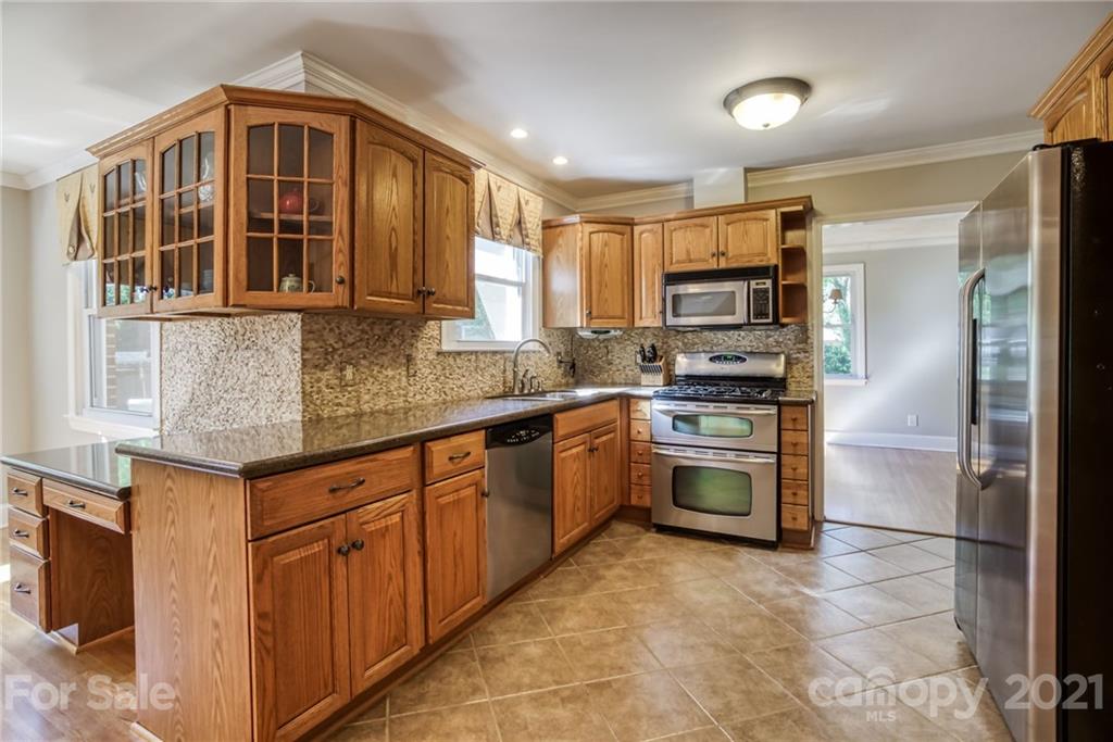 5401 Valley Forge Road Charlotte, NC 28210 - Photo 8 of 27 a kitchen with stainless steel appliances granite countertop a stove and a refrigerator