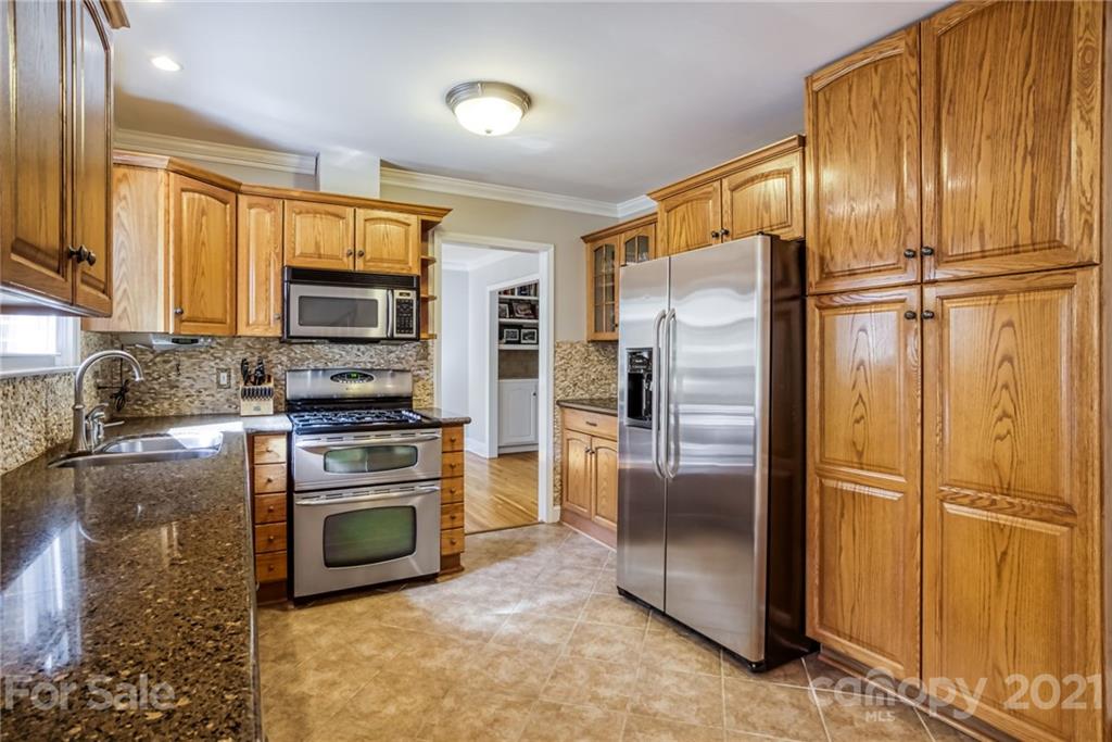 5401 Valley Forge Road Charlotte, NC 28210 - Photo 9 of 27 a kitchen with stainless steel appliances granite countertop a refrigerator stove and microwave