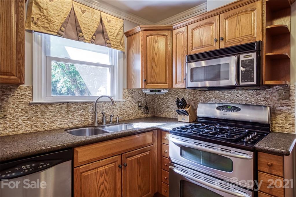 5401 Valley Forge Road Charlotte, NC 28210 - Photo 10 of 27 a kitchen with granite countertop a stove sink and cabinets