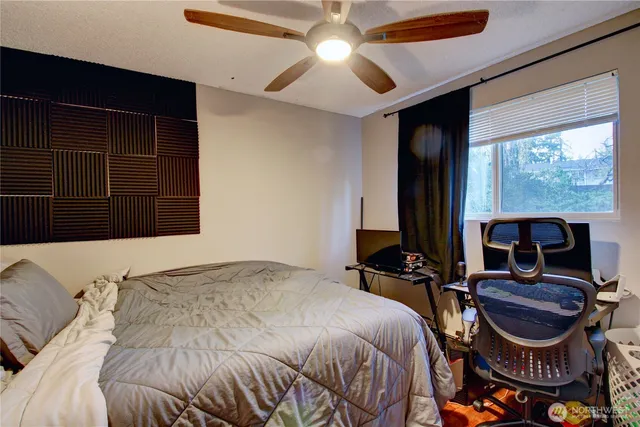 a bedroom with a bed a table and chair