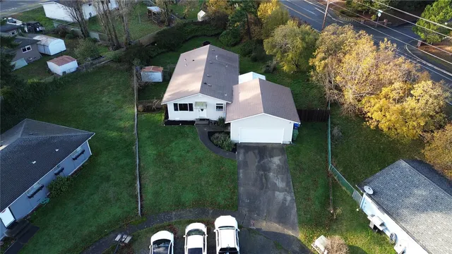 an aerial view of a house with swimming pool garden and patio