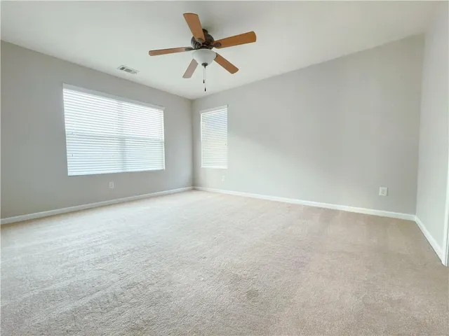 an empty room with a empty space and a ceiling fan