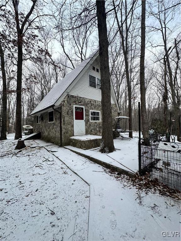 a view of a house with snow on the road