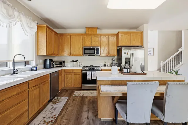 a kitchen with a sink cabinets and window