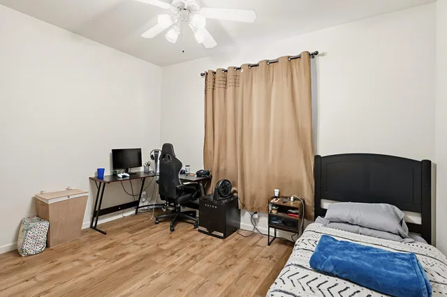 a bedroom with furniture and a wooden floor