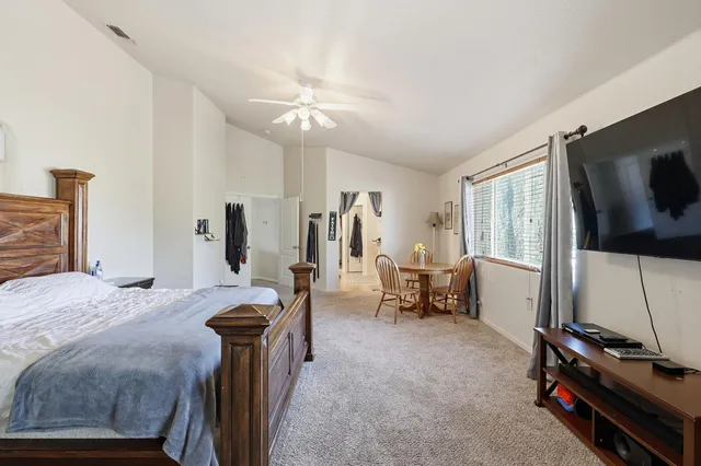 a bedroom with furniture and a flat screen tv