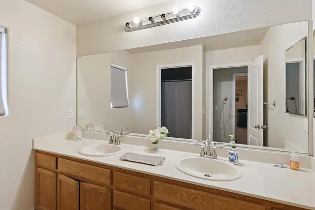 a bathroom with 2 sink and a mirror