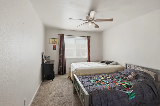 a bedroom with a bed and a chandelier