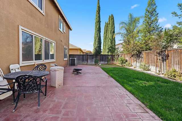 a view of a house with backyard and a sitting area