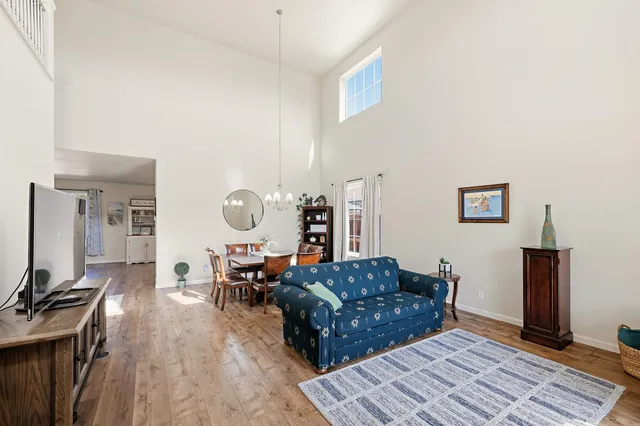 a living room with furniture a wooden floor and a flat screen tv