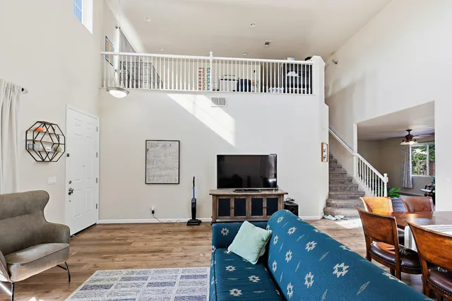 a bedroom with furniture and a flat screen tv