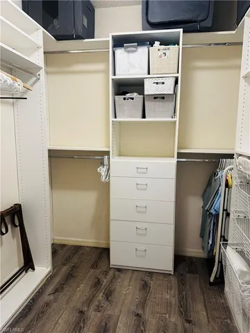 a view of walk in closet with empty racks