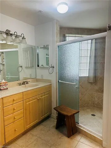 a bathroom with a double vanity sink toilet and shower