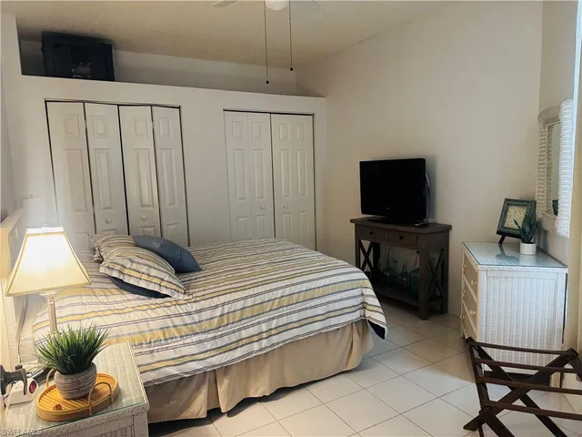 a bedroom with a bed and a chair