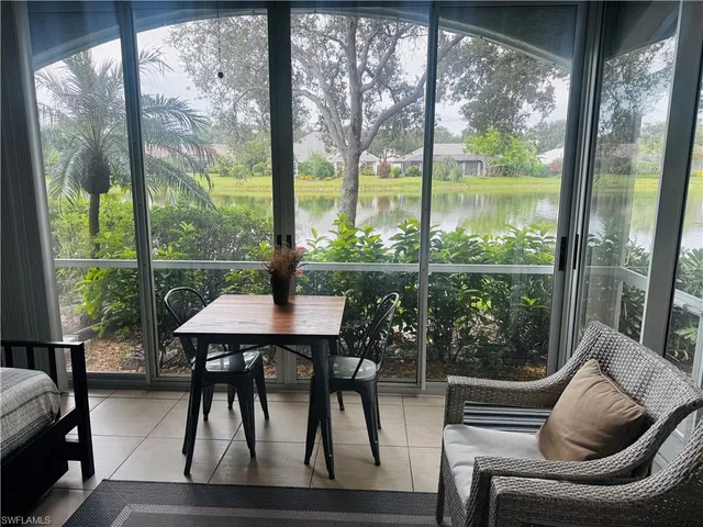 a view of a living room and floor to ceiling windows and wooden floor