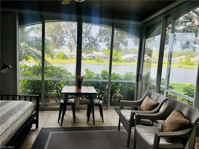 a balcony view with a large window and sitting space