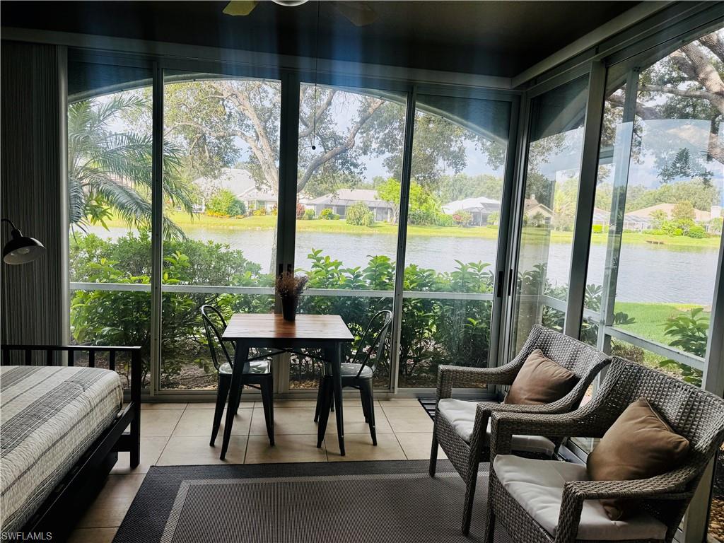 57 Silver Oaks Circle, Unit 103 Naples, FL 34119 - Photo 17 of 22 a balcony view with a large window and sitting space