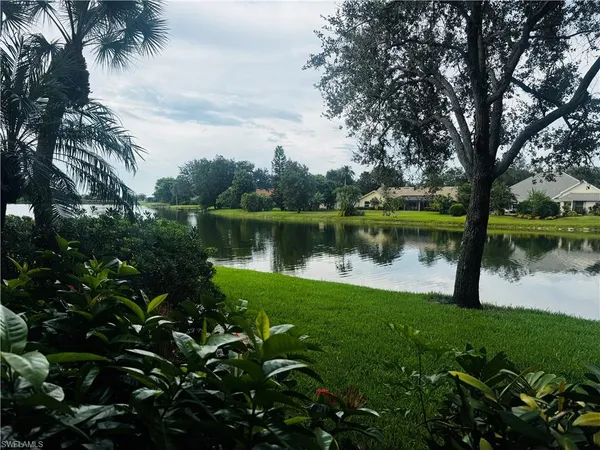 a view of a lake with a garden and trees