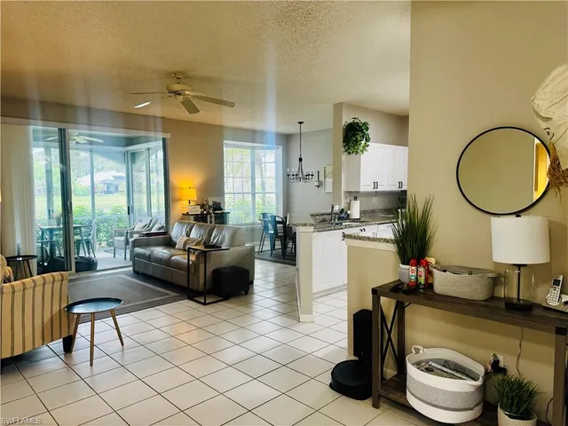 a living room with furniture and a mirror