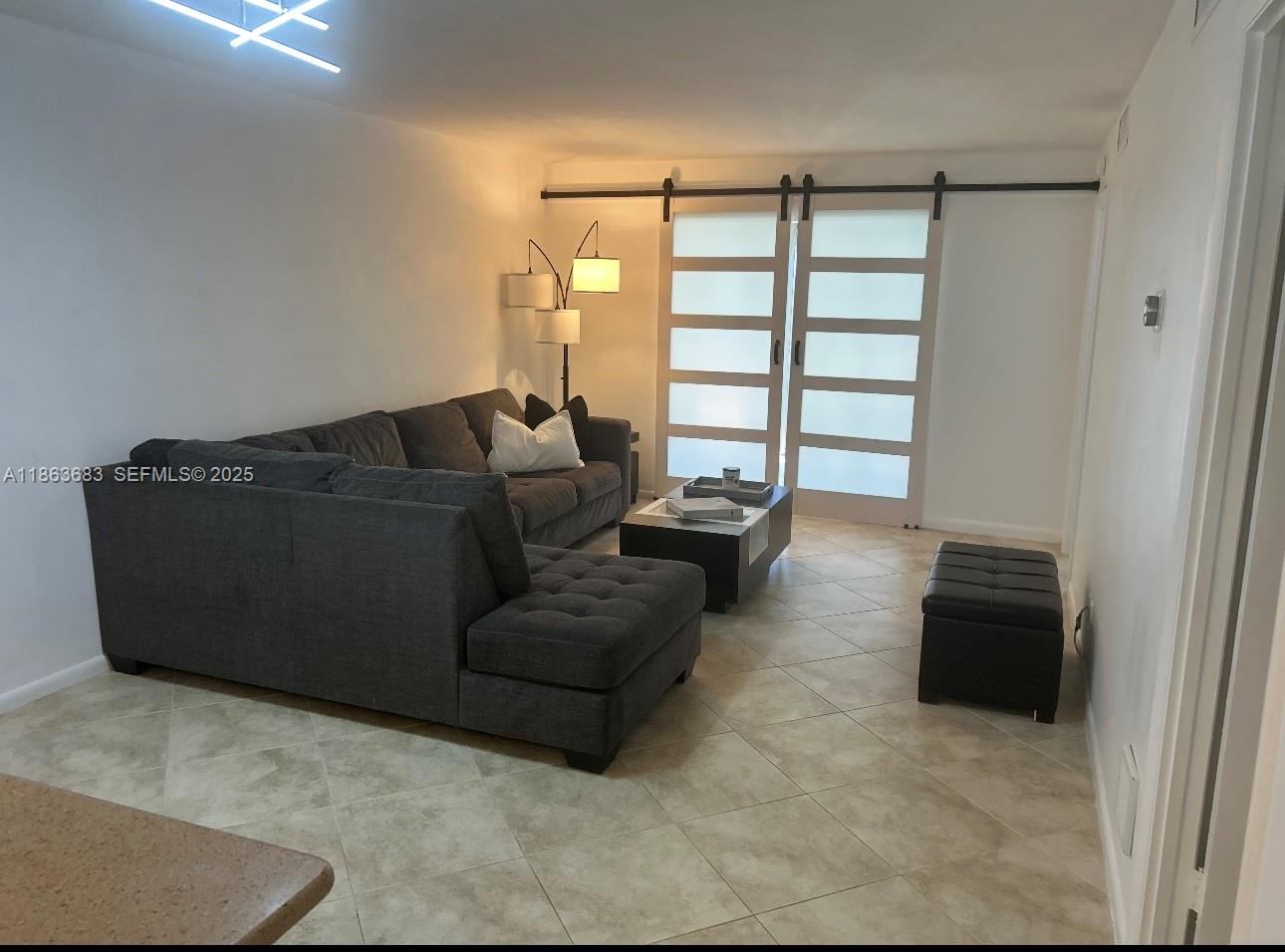 1900 Alamanda Drive, Unit 108 Naples, FL 34102 - Photo 13 of 20 a living room with furniture and a gate