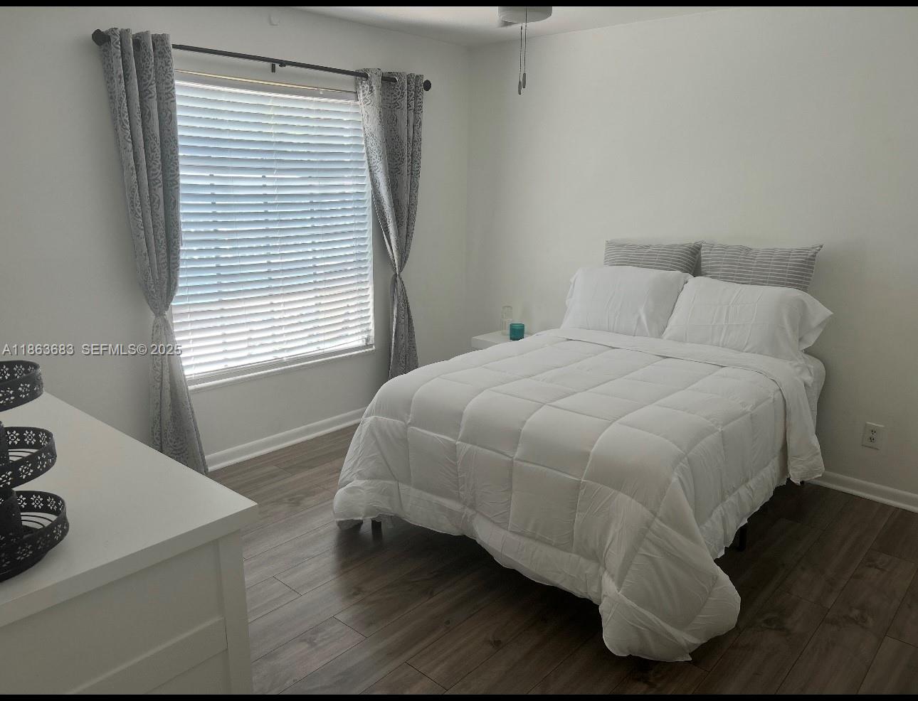 1900 Alamanda Drive, Unit 108 Naples, FL 34102 - Photo 16 of 20 a bedroom with a bed and a window