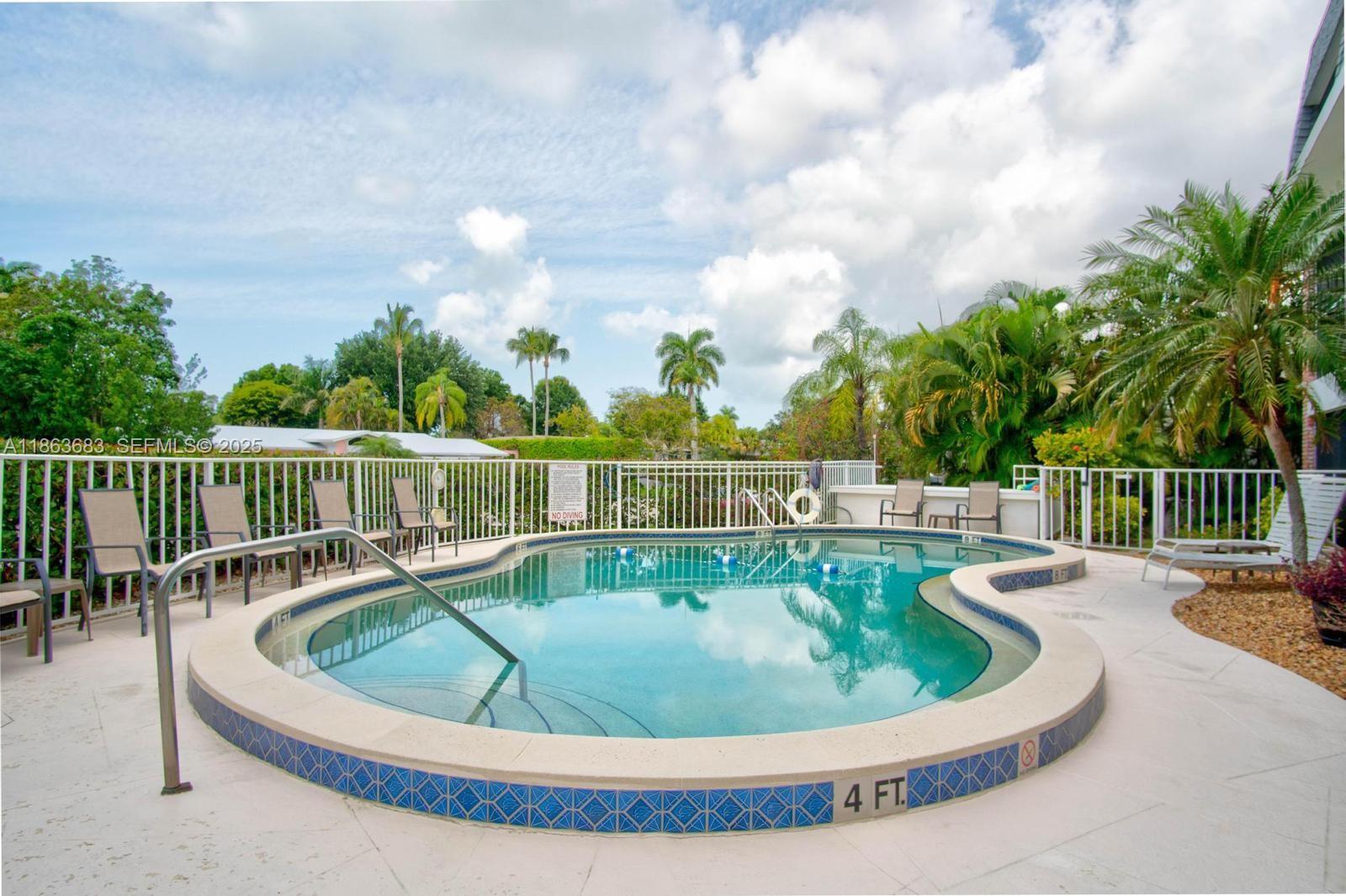 1900 Alamanda Drive, Unit 108 Naples, FL 34102 - Photo 19 of 20 a view of a swimming pool with a back yard