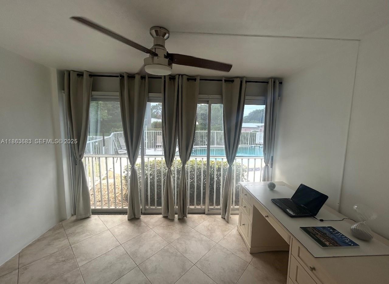 1900 Alamanda Drive, Unit 108 Naples, FL 34102 - Photo 8 of 20 a view of room with balcony and furniture