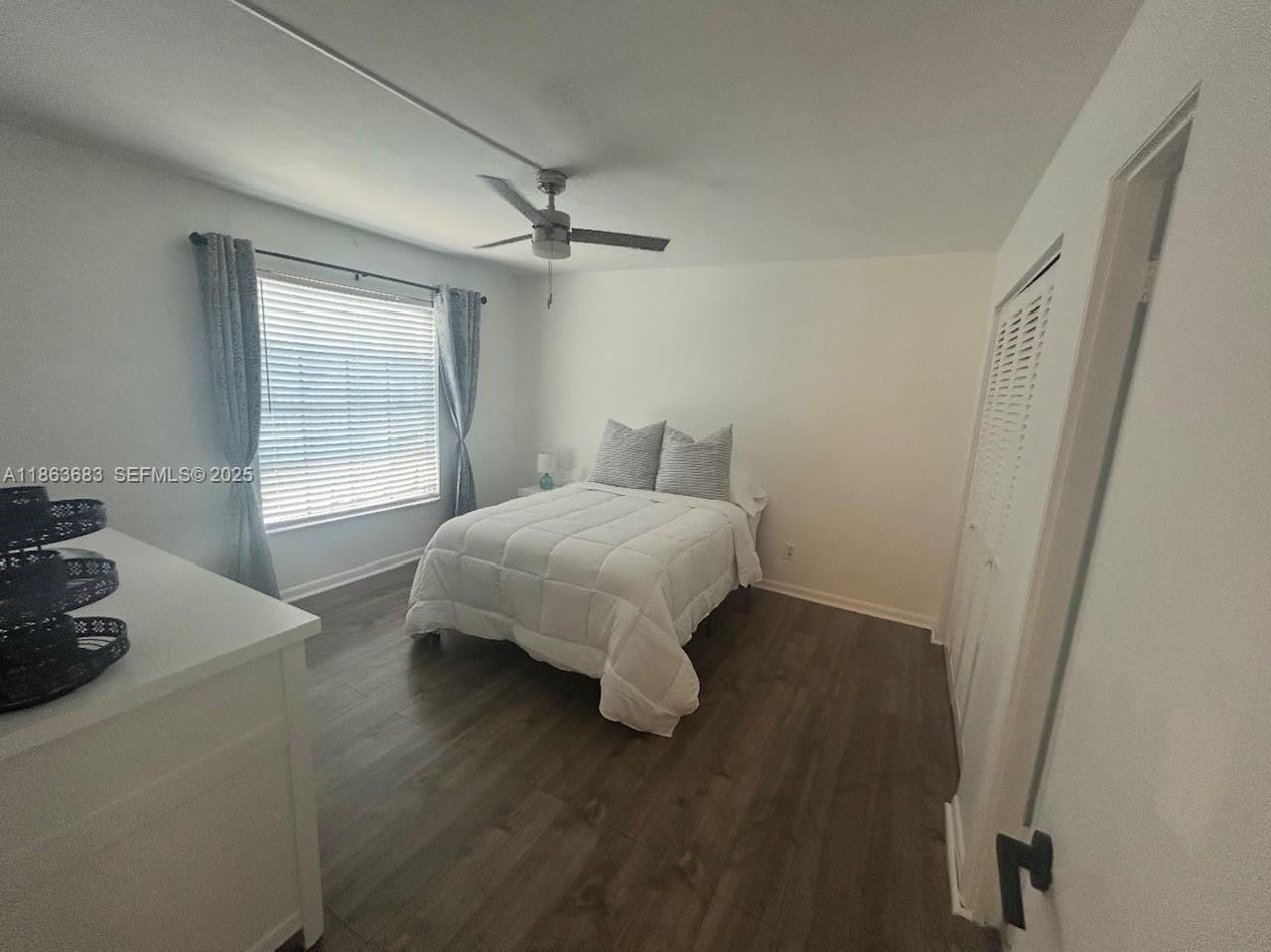 1900 Alamanda Drive, Unit 108 Naples, FL 34102 - Photo 10 of 20 a bedroom with a bed and a window