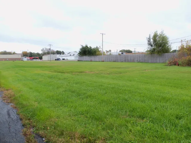 a view of a field and trees