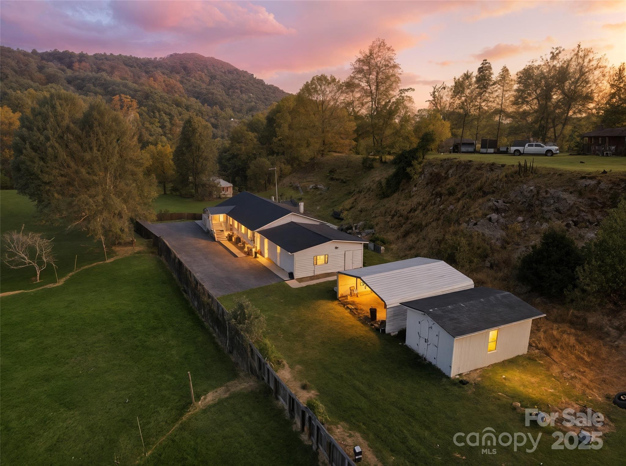 a view of a house with a yard and a mountain view