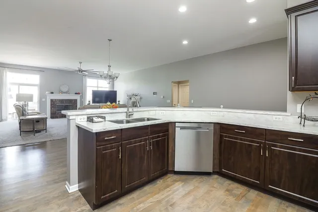 a kitchen with a sink cabinets and wooden floor