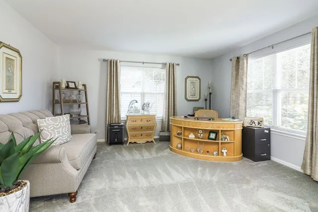 a spacious bedroom with a bed and a large window