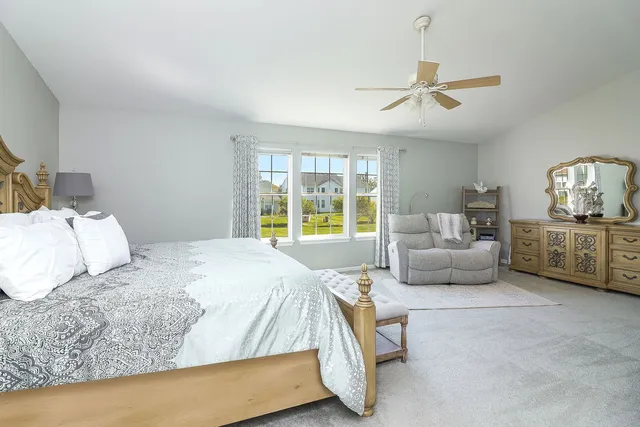 a bedroom with a bed a couch and dresser