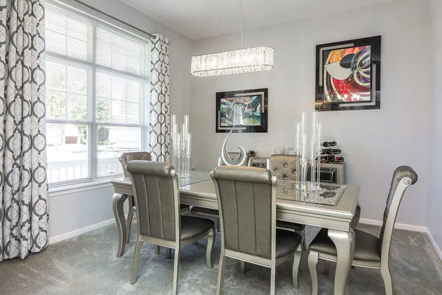 a dining room with furniture and window