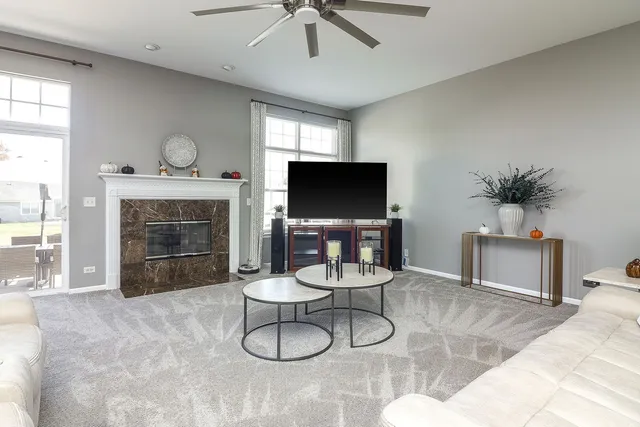 a living room with furniture a fireplace and a flat screen tv
