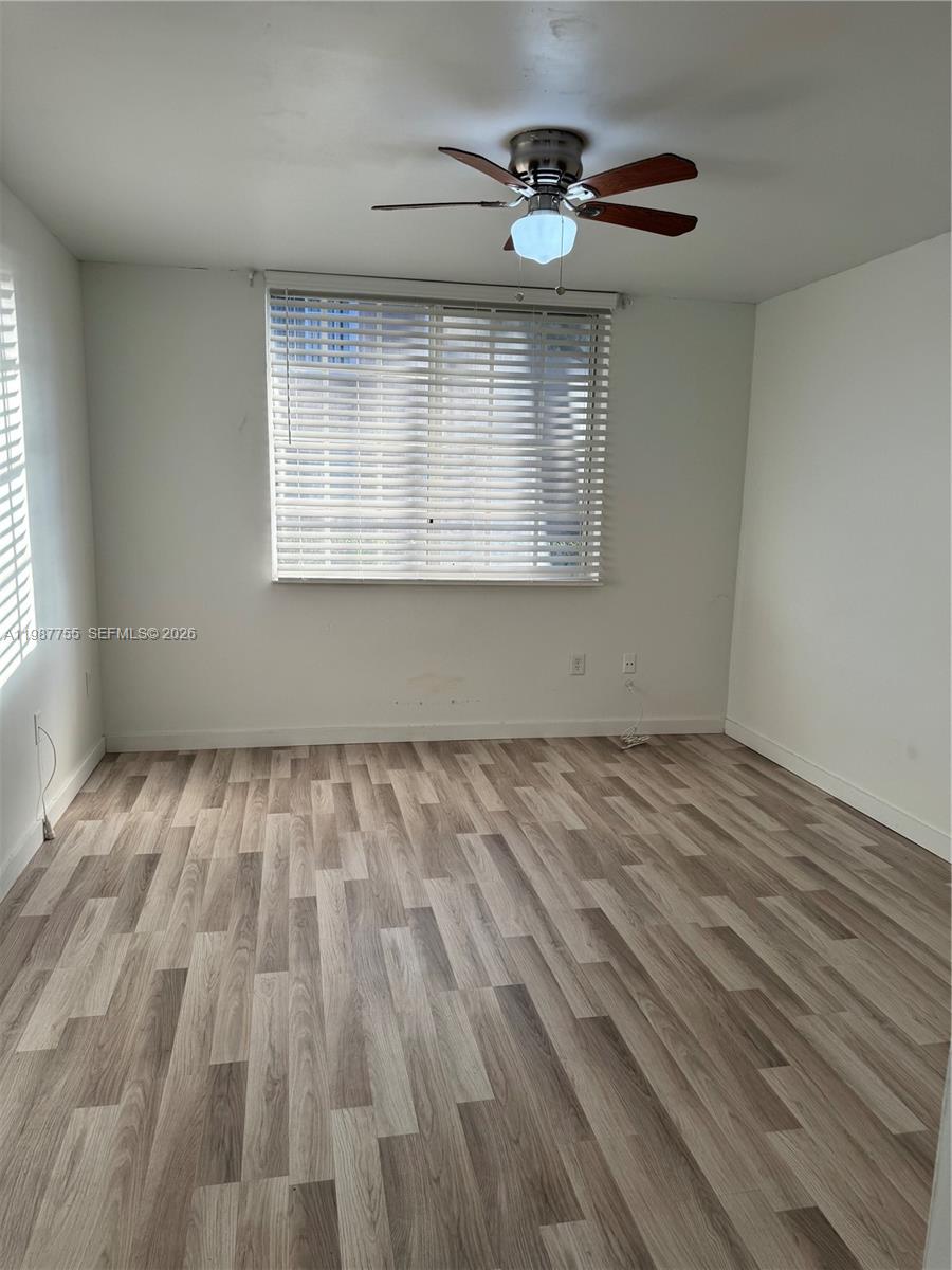 2071 Renaissance Boulevard, Unit 104 Miramar, FL 33025 - Photo 17 of 17 wooden floor in an empty room with a window