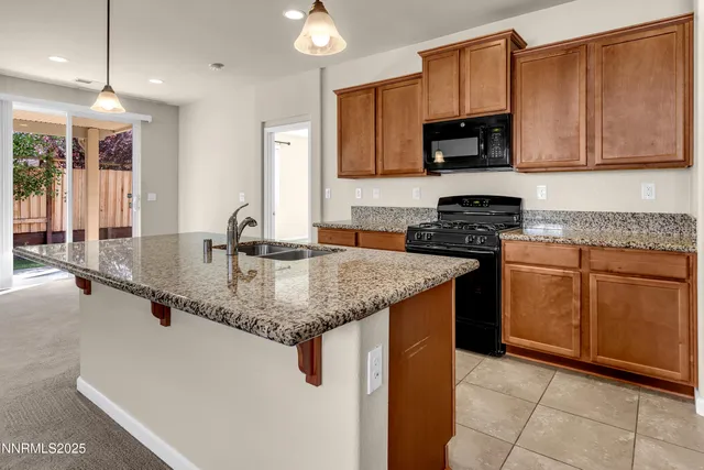 a kitchen with stainless steel appliances granite countertop a sink stove and microwave
